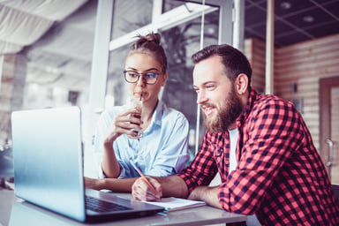 man and woman looking at a computer screen