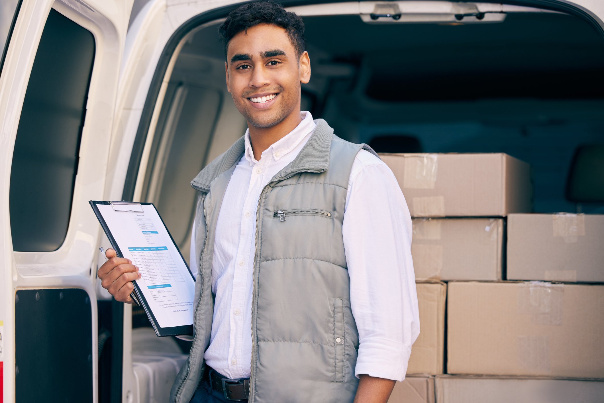 Delivery Man with Clipboard Behind Goods Van