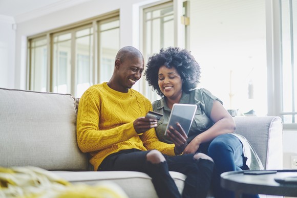 Two people sitting on a couch.
