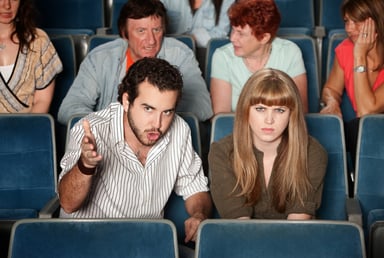 Frowning movie theater viewers