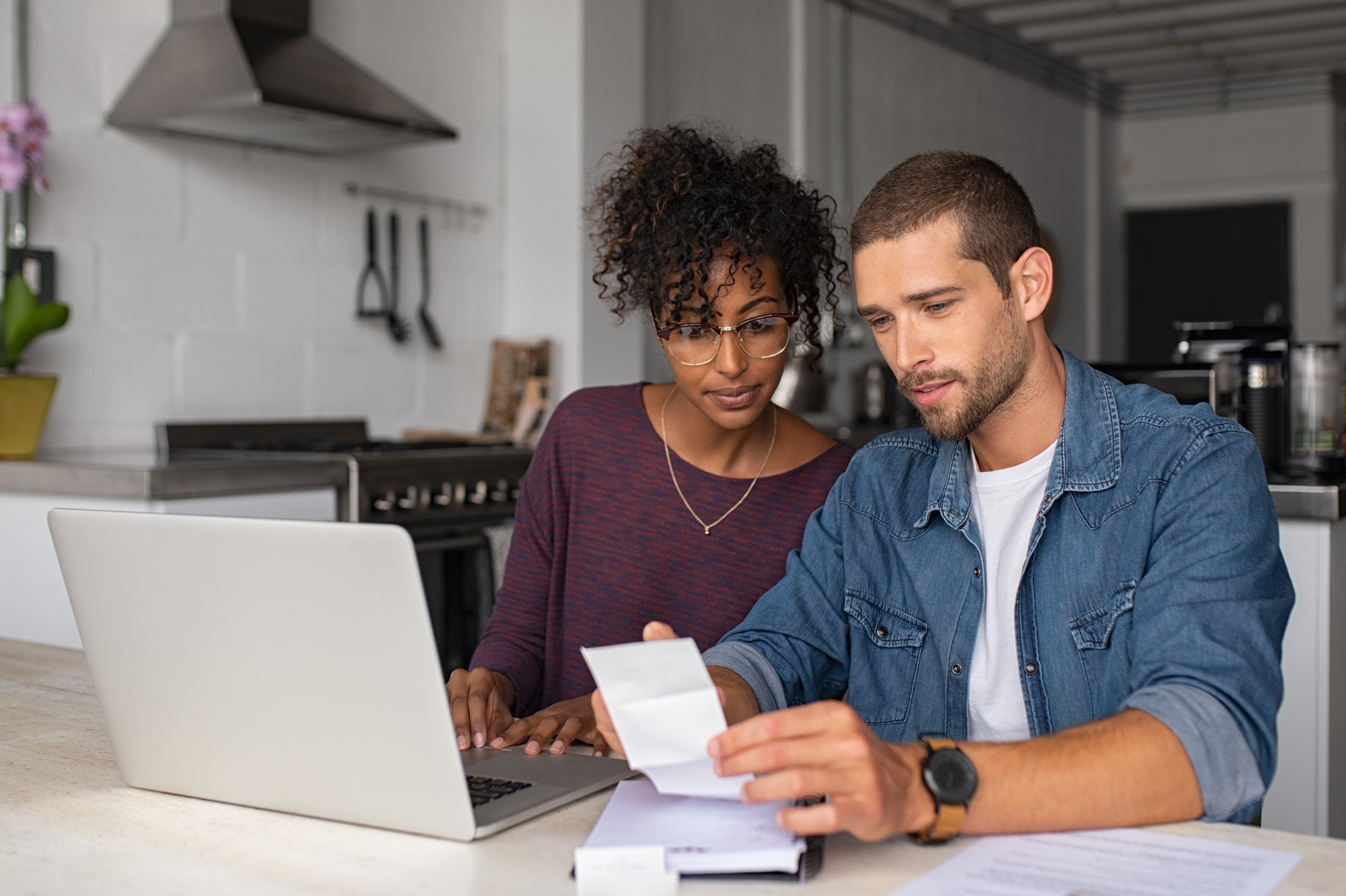 Two people looking at a laptop.