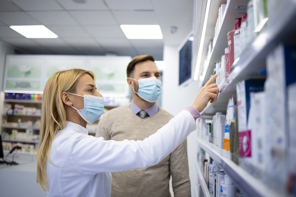 A pharmacist consults with a customer.