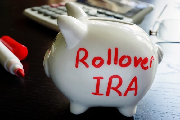 Piggy bank with the words Rollover IRA written on it.