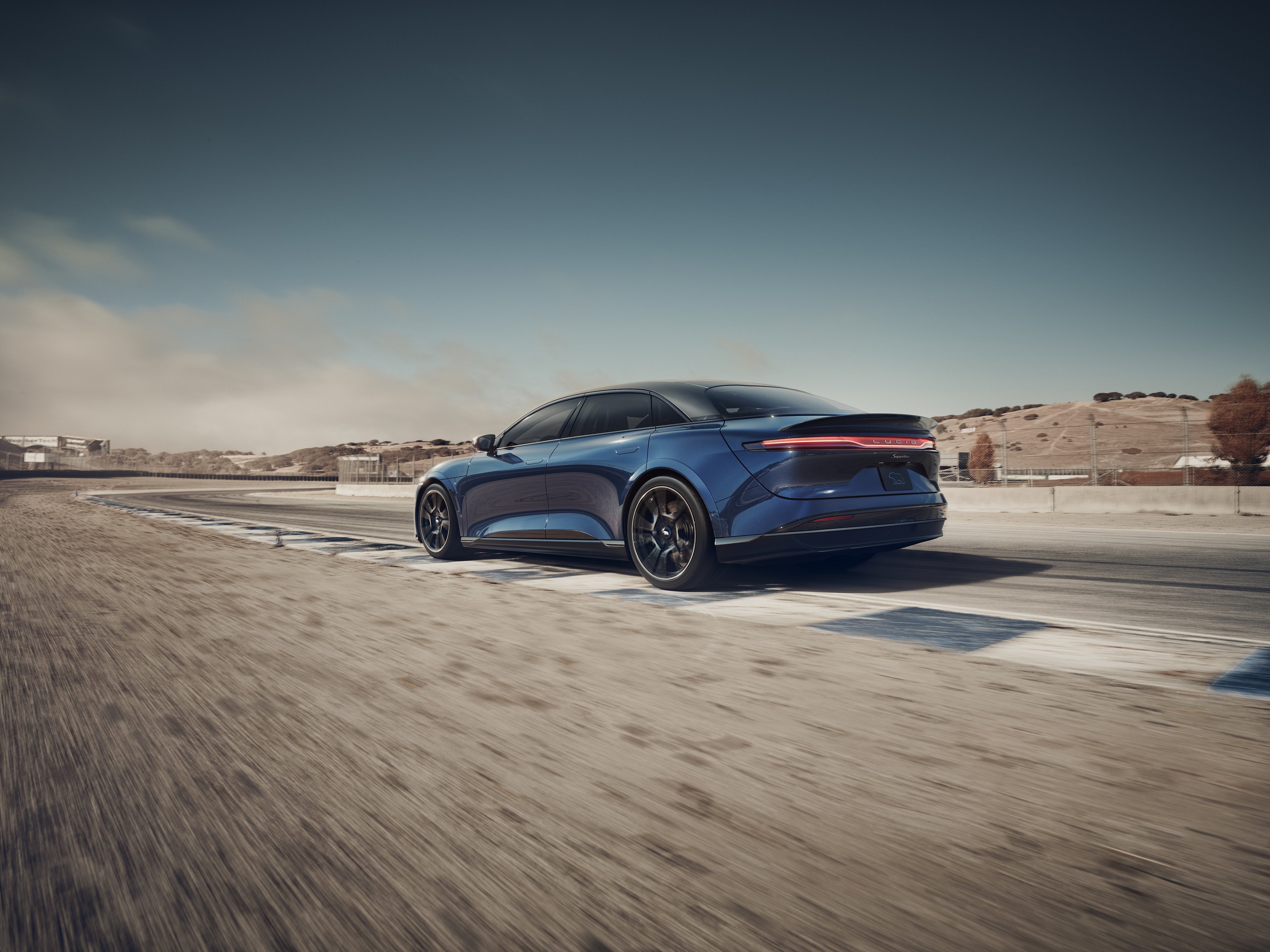 Blue Lucid Air Sapphire driving on a track. 