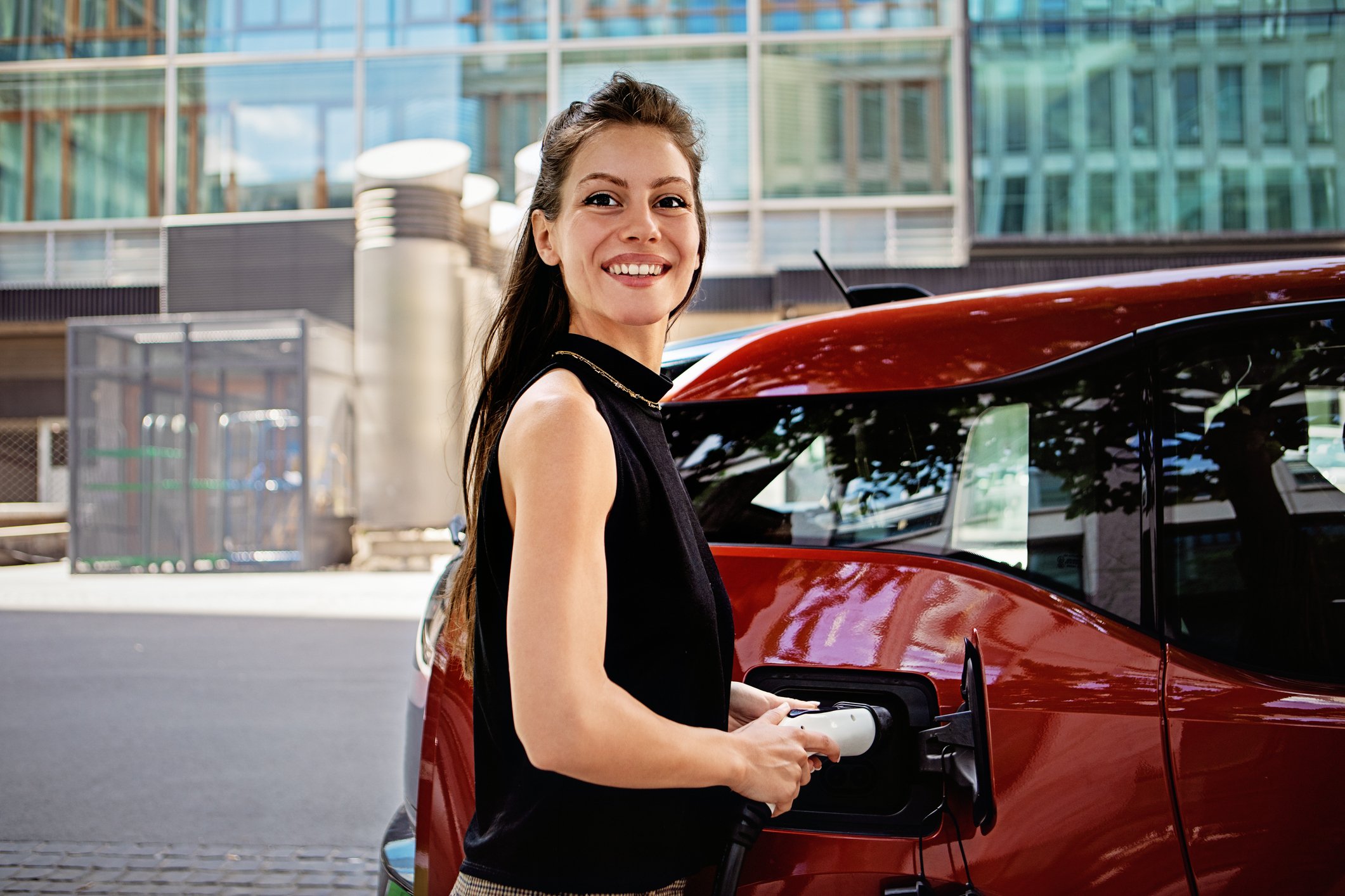 a driver charges an electric vehicle.