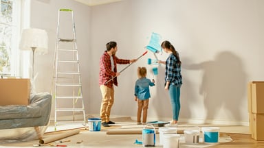 a family painting a wall