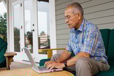 Older man laptop outdoors GettyImages-56957014