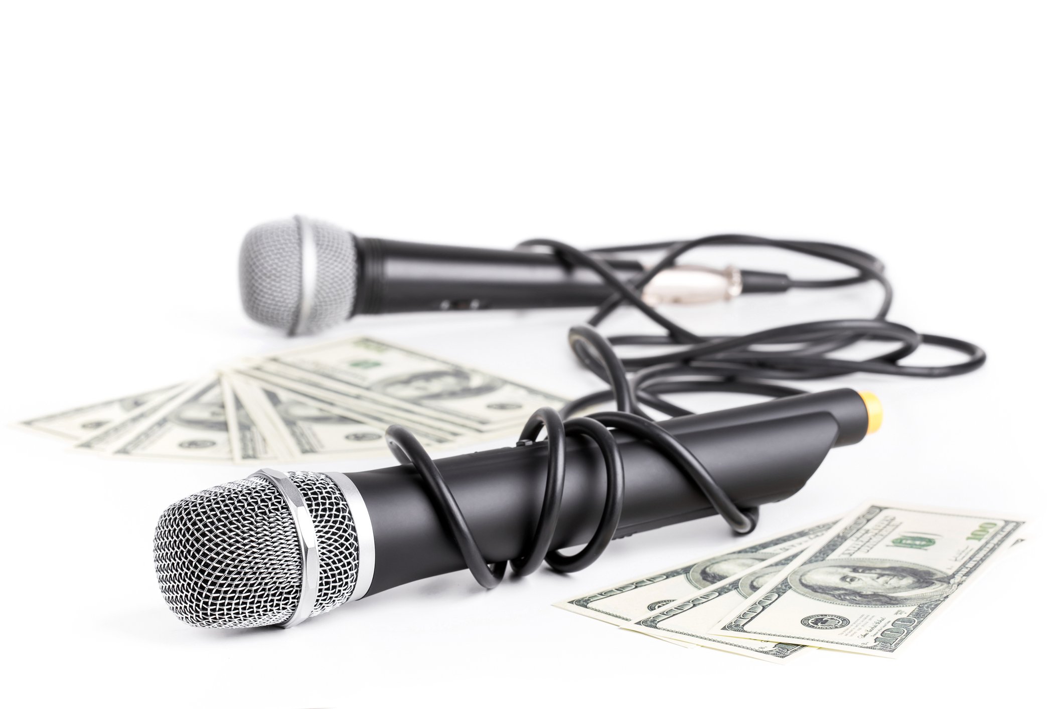 Two microphones next to bills of US currency