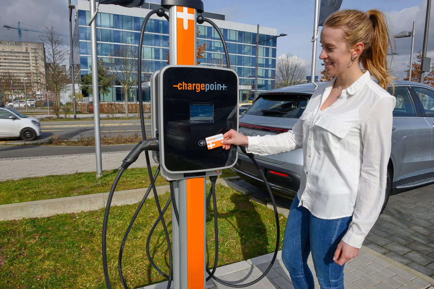 EV owner swipes card at ChargePoint public charger. 