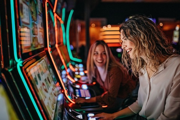 People playing slot machines at a casino.