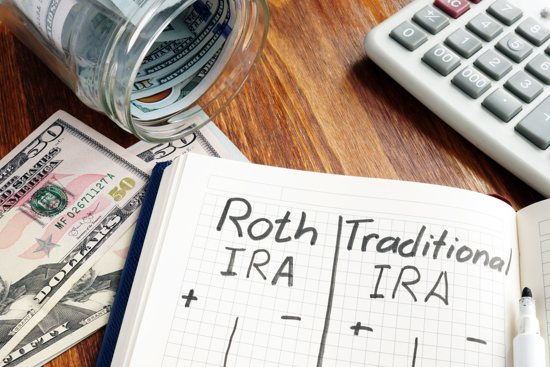 A notebook with notes comparing a Roth IRA vs a Traditional IRA.