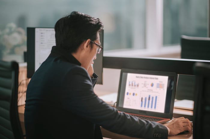 A businessperson works on a laptop.