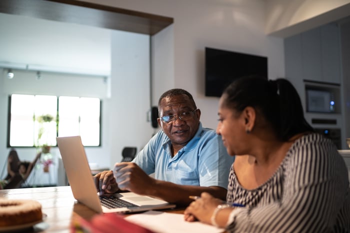 Couple looking at financial paperwork. 