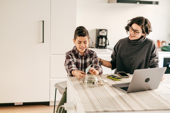 Two people look over their finances at the table.