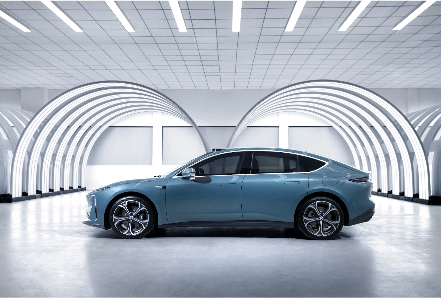 profile view of blue Nio ET5 sedan. 