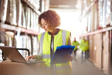 fulfillment center worker uses laptop