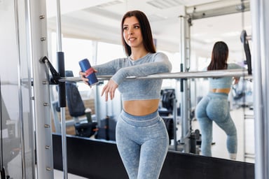 Lady Drinks Energy Drink at Gym