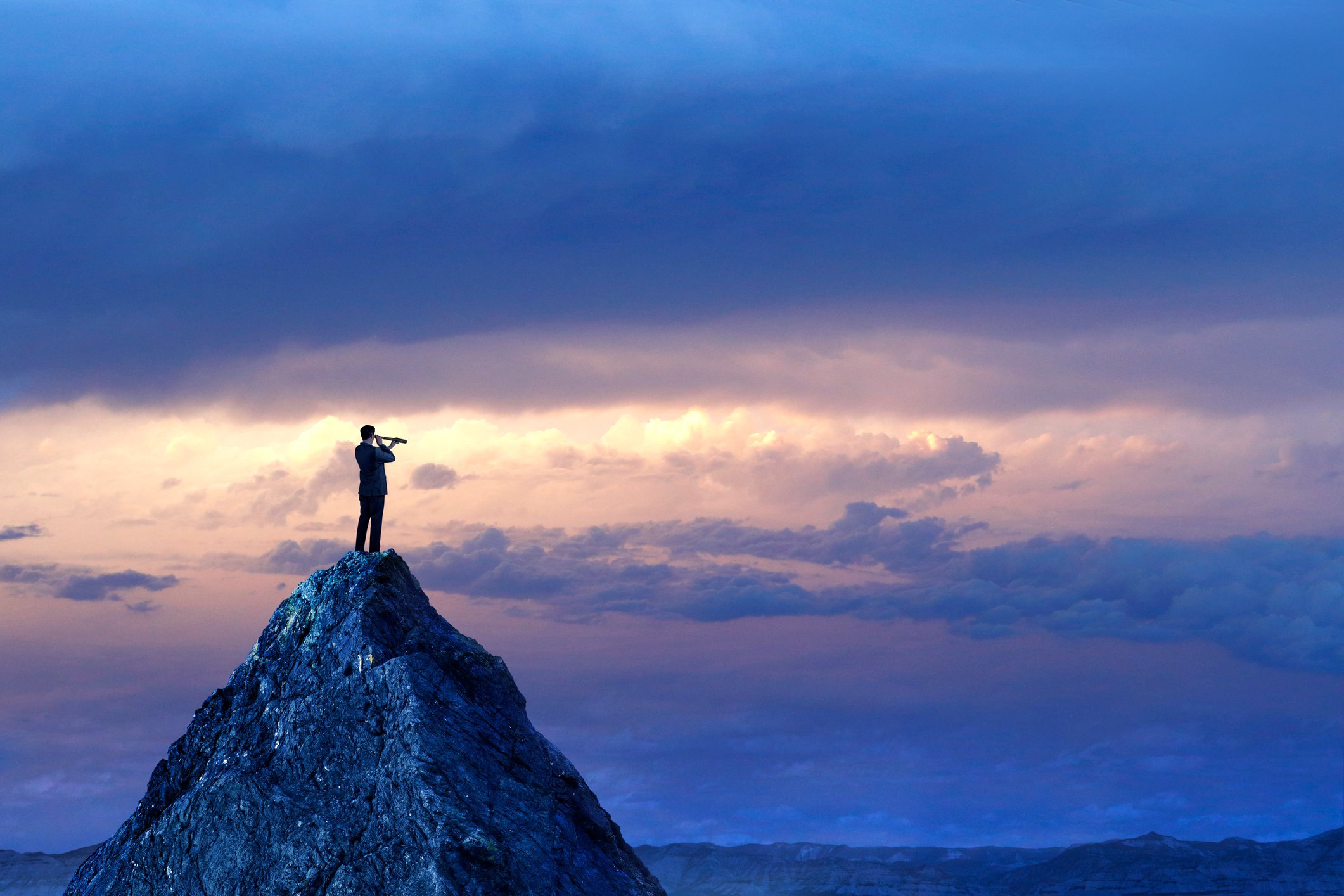 Person on mountain with telescope