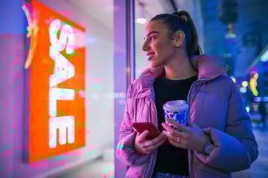 shopper sees sale sign in window