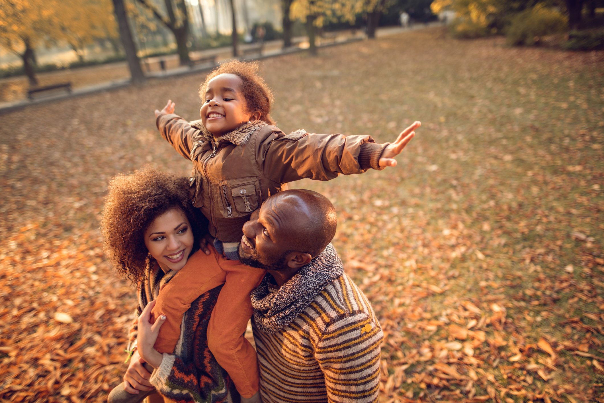 People playing in fall leaves