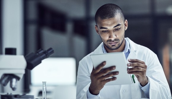 Scientist looking a at a tablet.