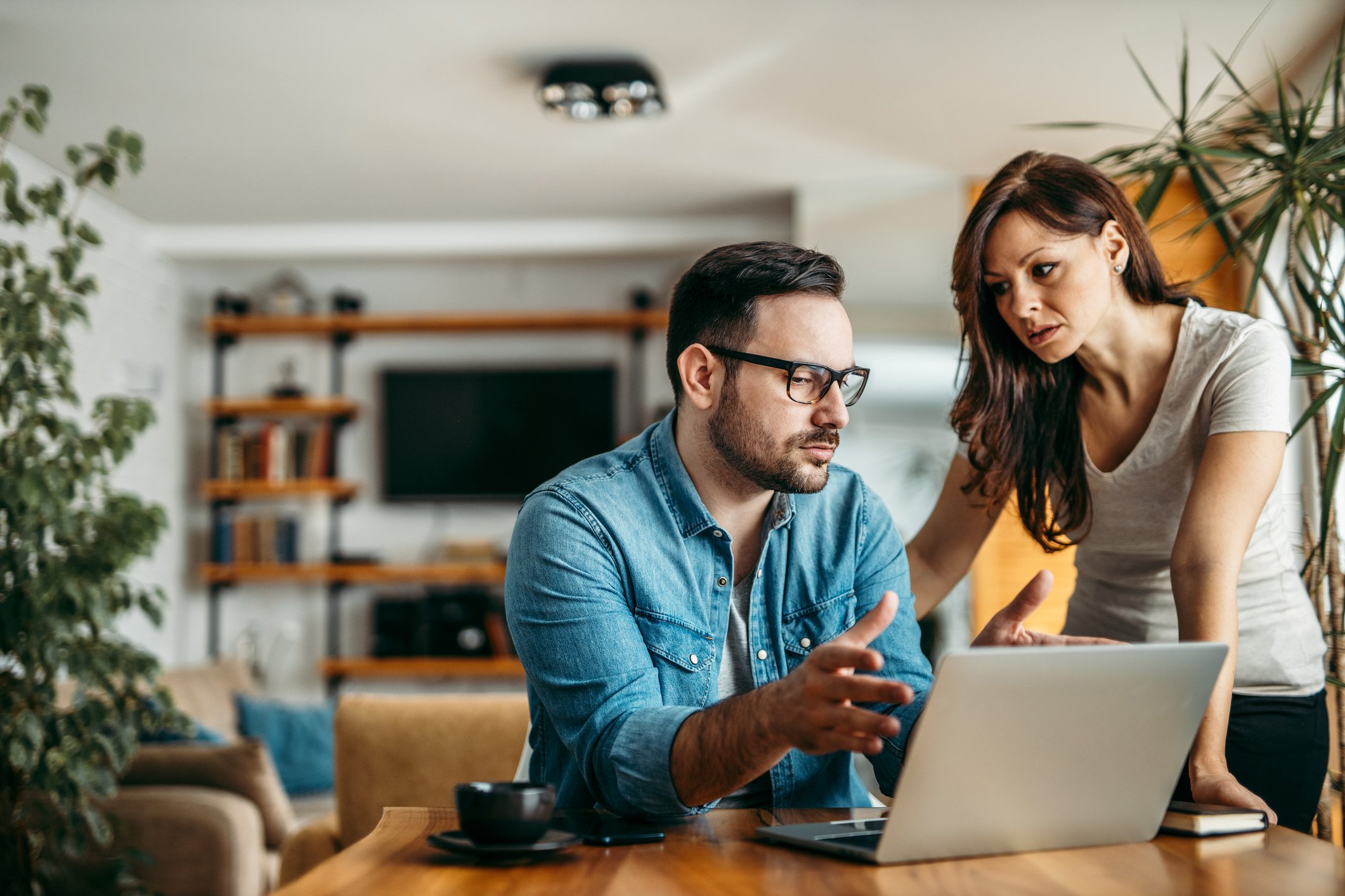 Two people in front of a laptop.