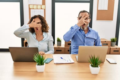 People holding hands over eyes laptops