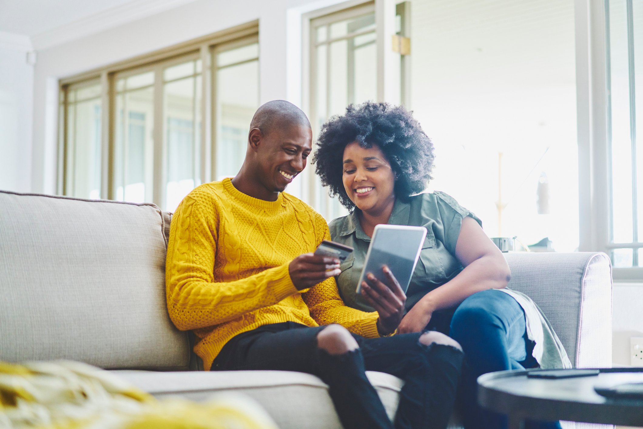 Two people sitting on a couch.