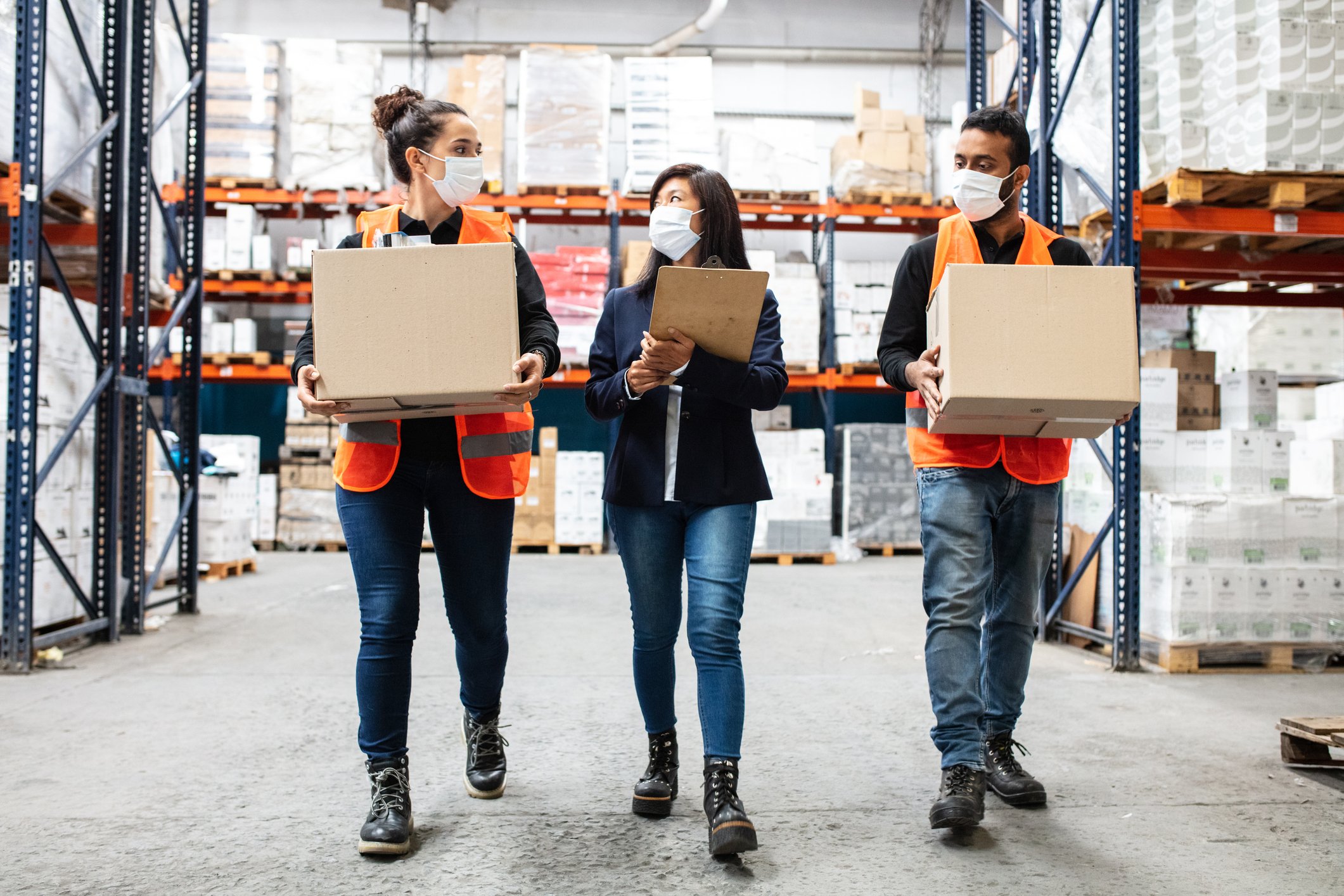 three masked warehouse workers