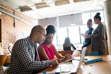 coworkers collaborate in a crowded office