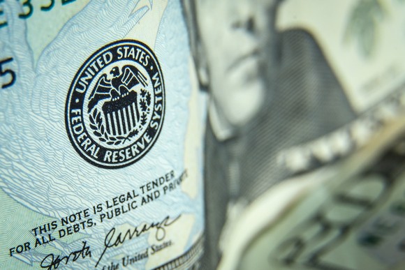 A close up view of a Twenty-dollar bill focusing on the Federal Reserve logo that appears on the $20 bill