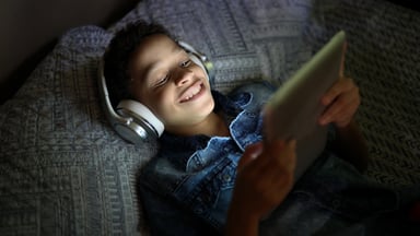 Kid watching tablet with headphones