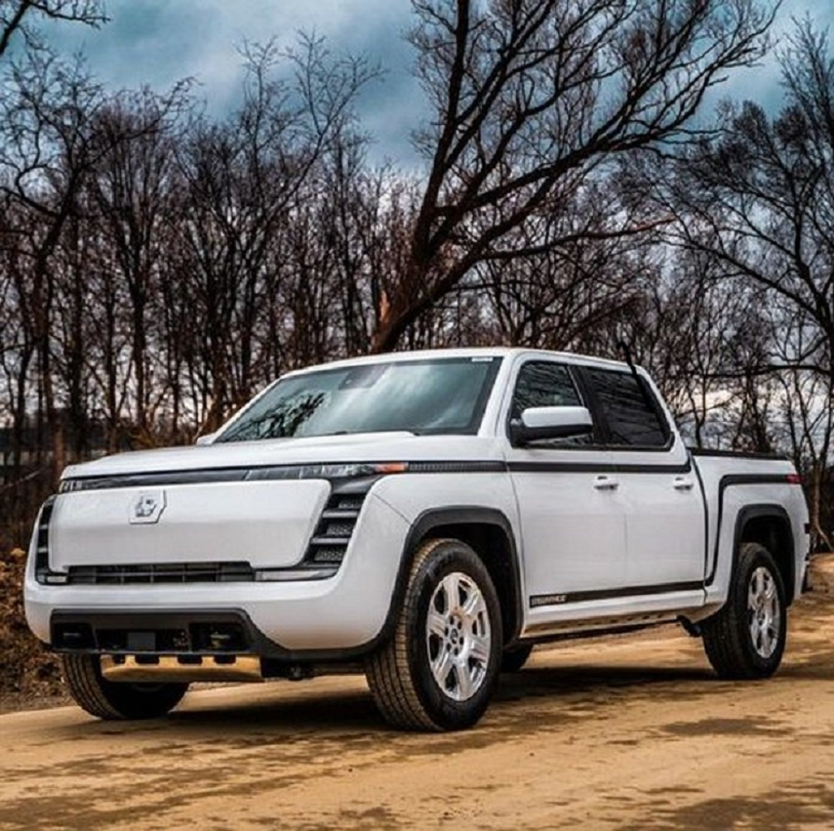 Endurance electric truck on a dirt road at dusk.