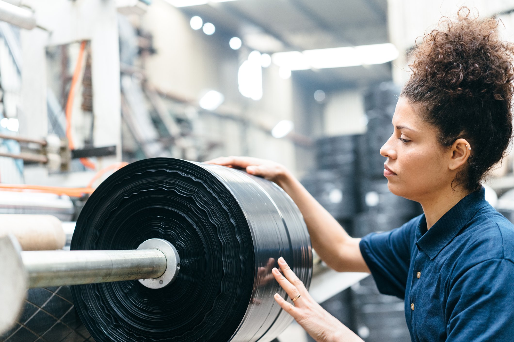 A person working in a plastic recycling factory. 