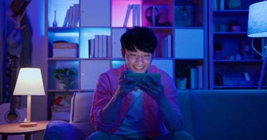 a young man playing a mobile game