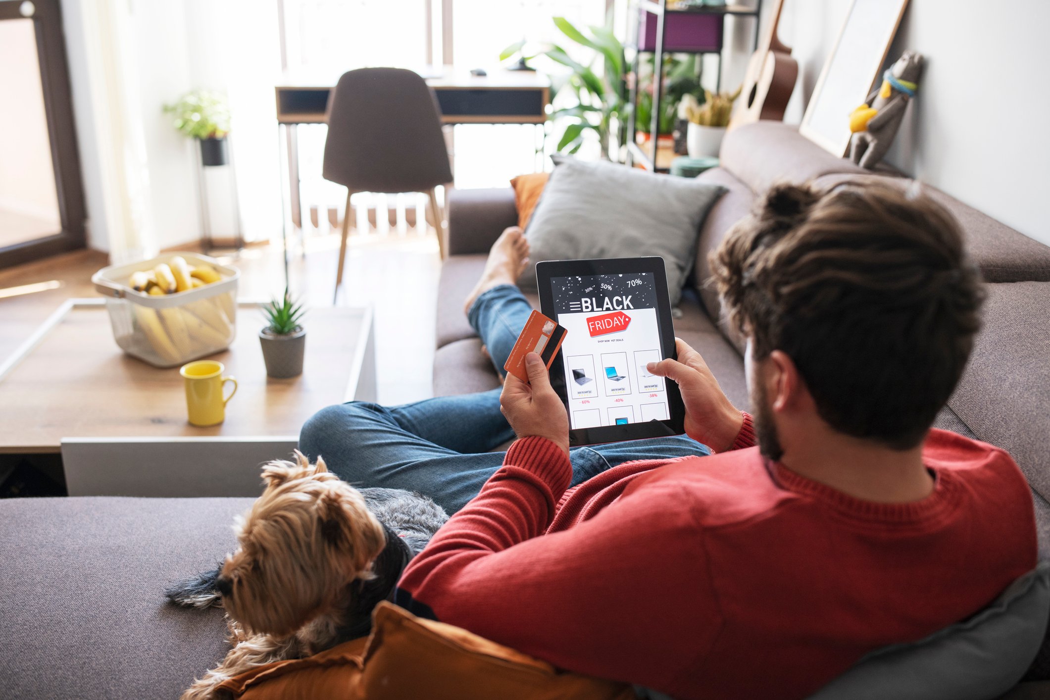 A person online shopping with a tablet.