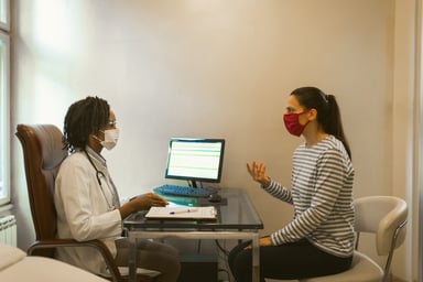A doctor meets with a patient for an appointment