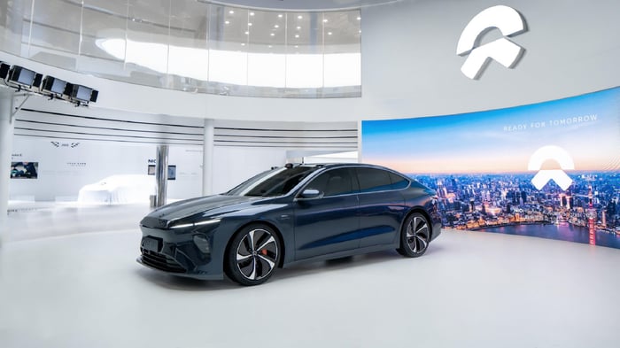 An all-electric Nio ET7 sedan on display in a showroom.