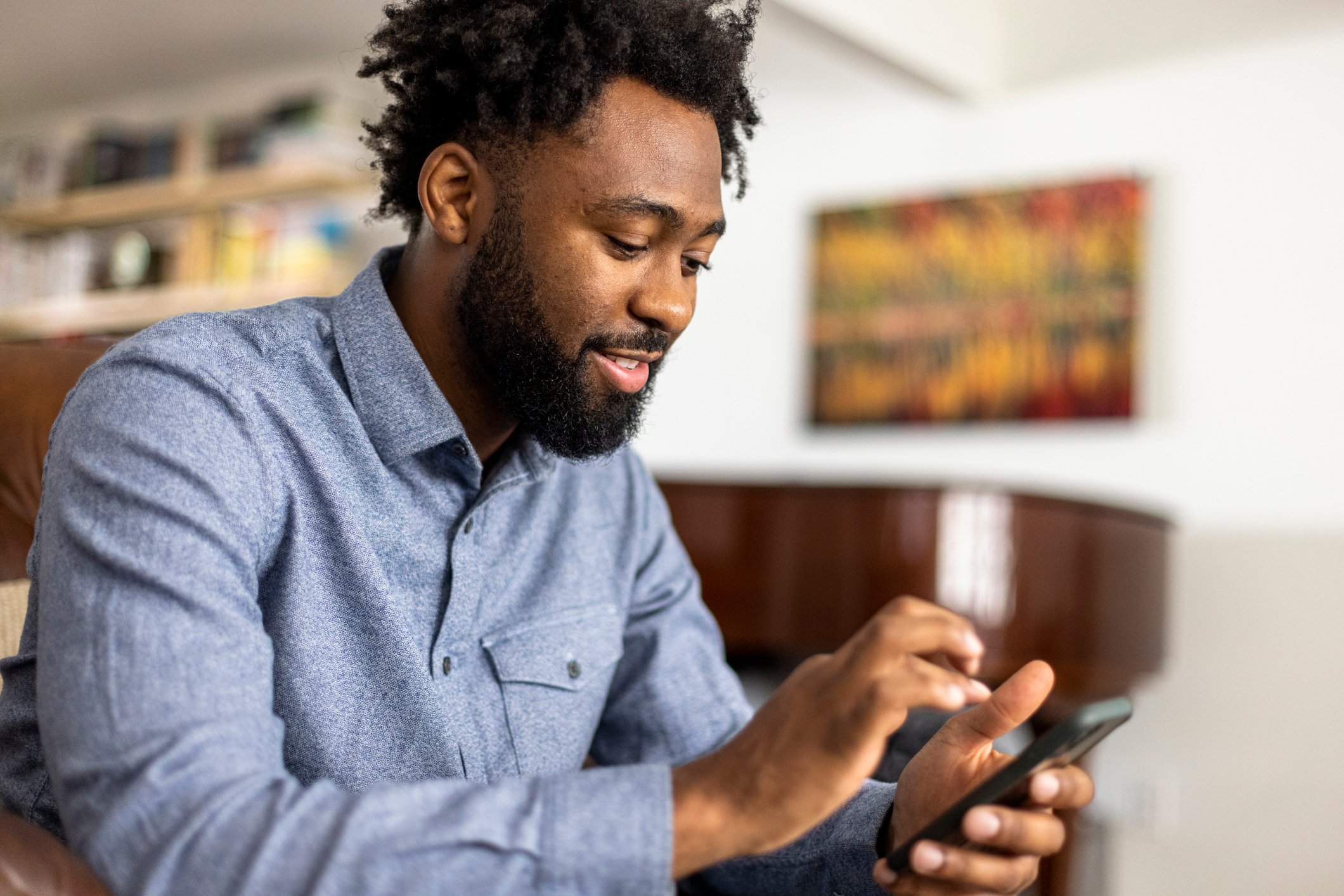 African-American man holding a smartphone
