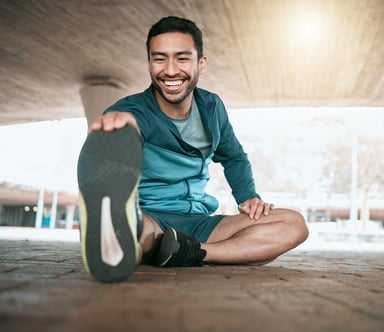 Young Man Stretching Before a Run