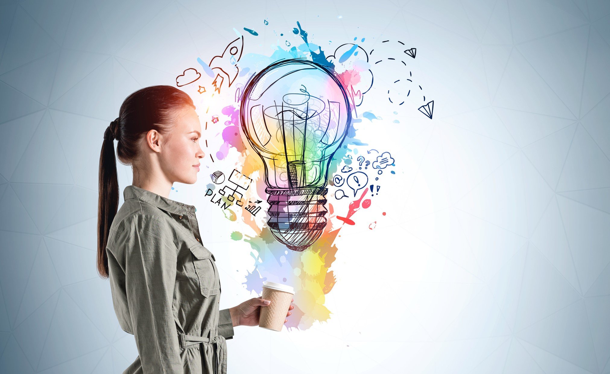 A person visualizes a light bulb surrounded by ideas.