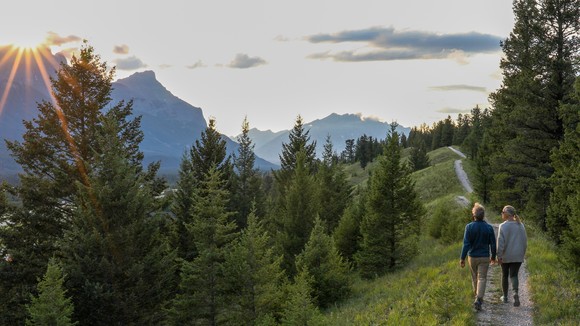 Couple walking on mountain path. 