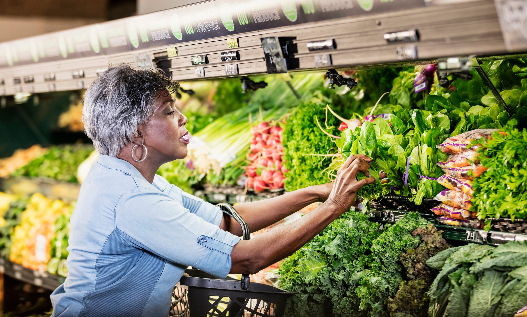 A person in the produce aisle of a grocery store.