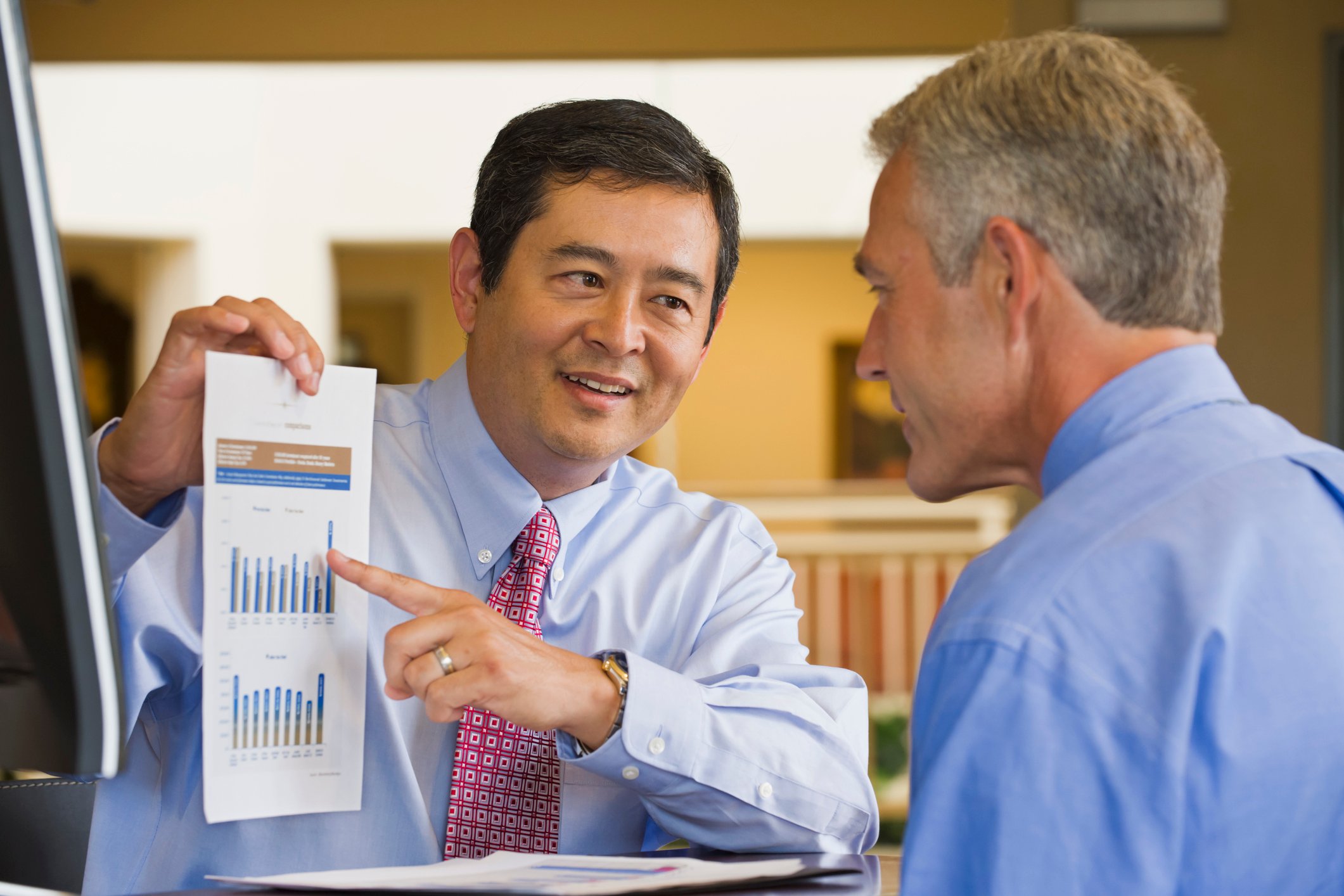 Businessman showing chart to co-worker.