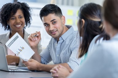 People discussing a sales report.