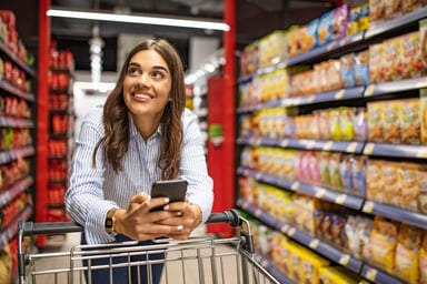 Person holding phone and shopping in  supermarket .