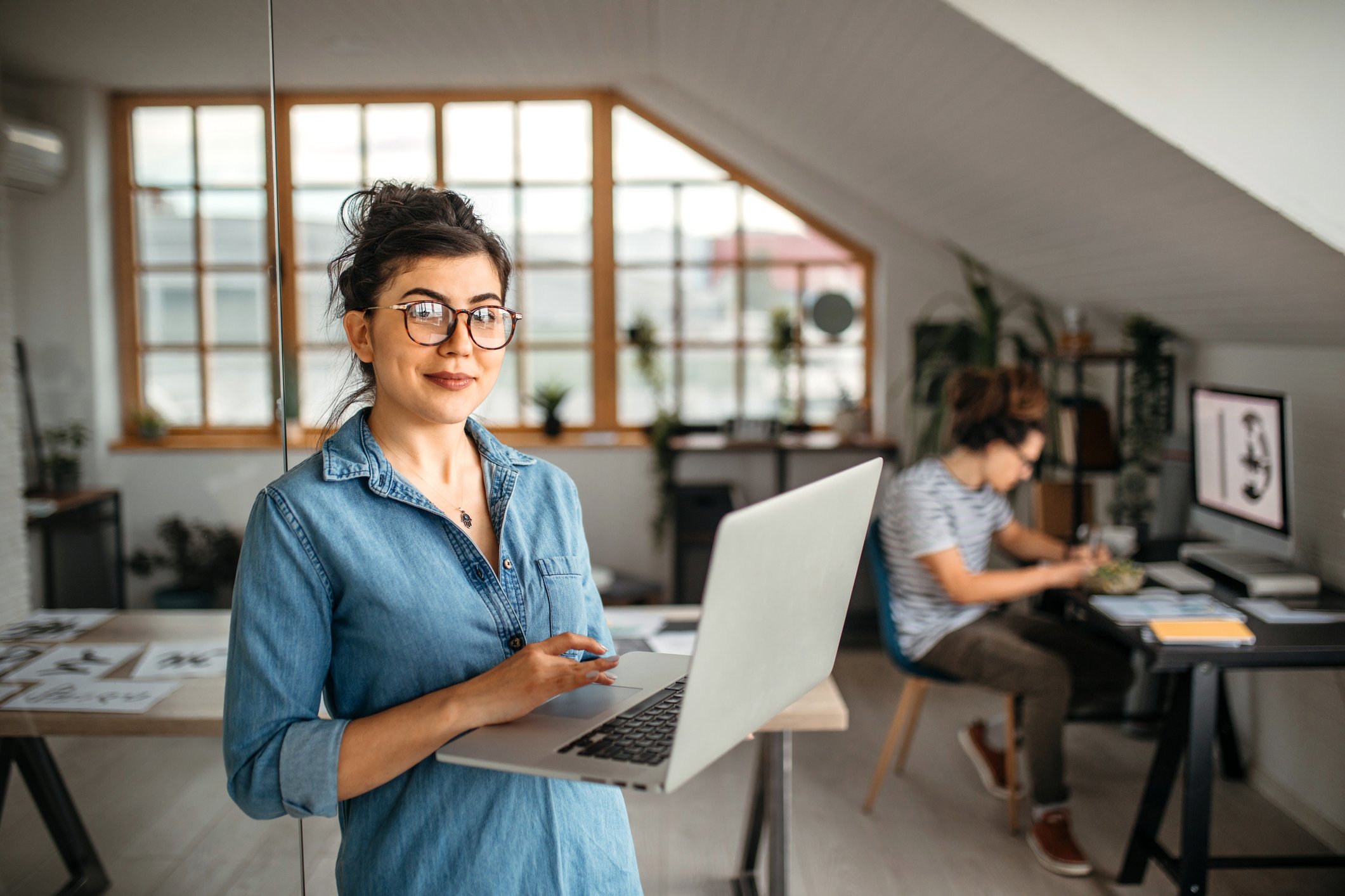 Young Lady Standing with Laptop in Home Office