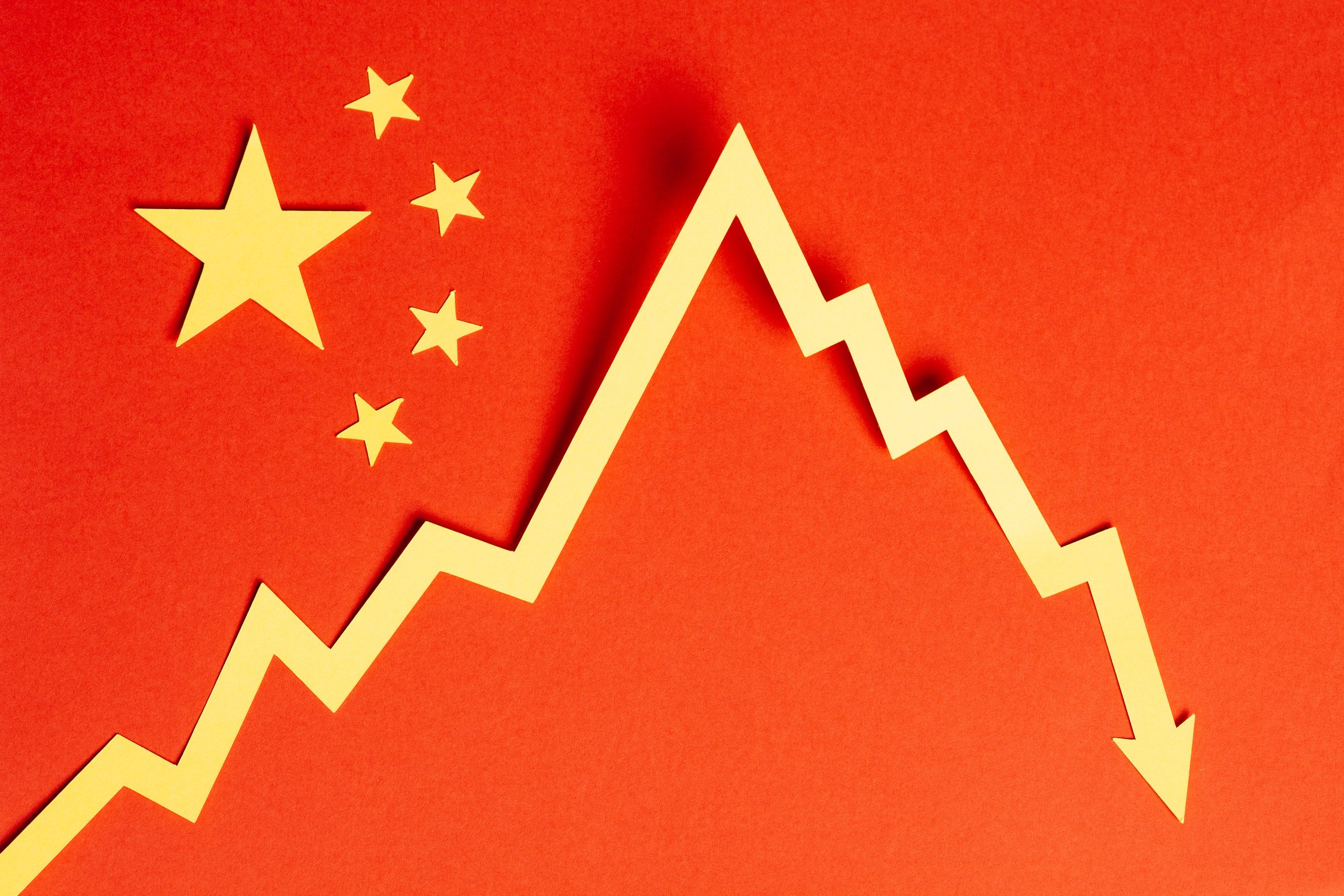 A declining stock chart on a Chinese flag.