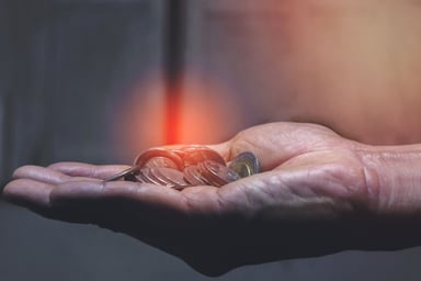 hand holding coins interest dividends