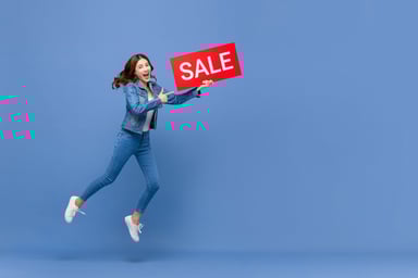 shopper jumps in air with sale sign
